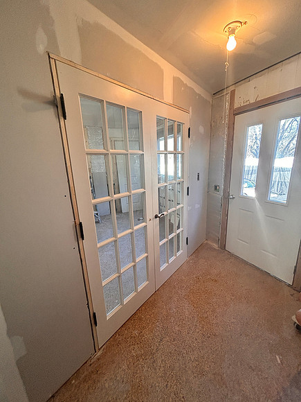 new wall and doors between living area and kitchen. front door